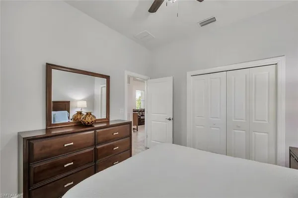 a bedroom with a bed and a dresser