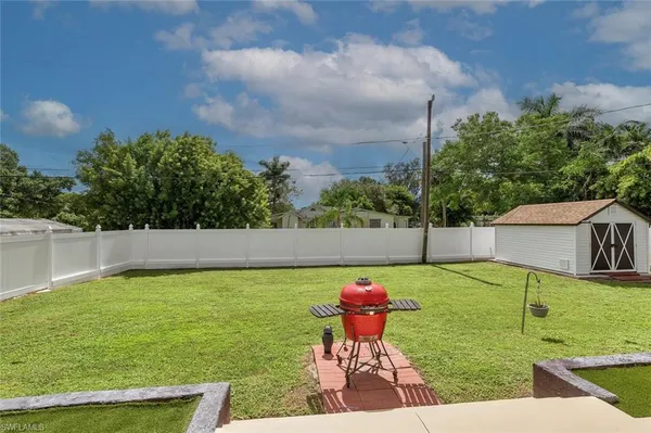 a view of a backyard with swimming pool