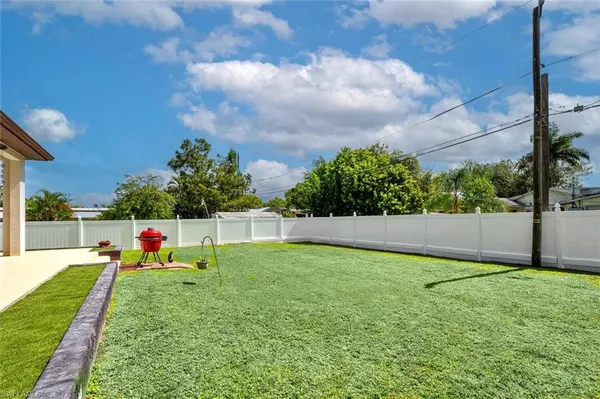 a view of a backyard with swimming pool