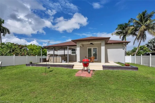 a view of a house with a yard and sitting area