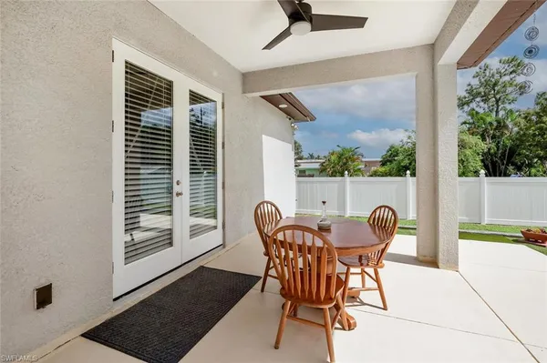 a view of a dining room with furniture and a window