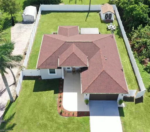 an aerial view of a house with a yard