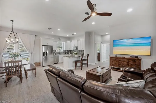 a living room with furniture and kitchen view