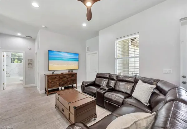 a living room with furniture or couch and a flat screen tv