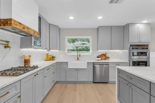 a kitchen with kitchen island granite countertop a sink cabinets and window