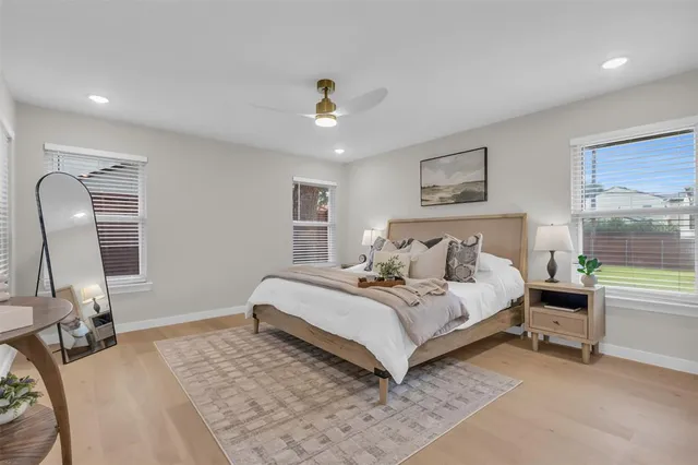 a spacious bedroom with a bed couch and a window