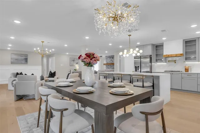 a kitchen with a dining table cabinets and chairs