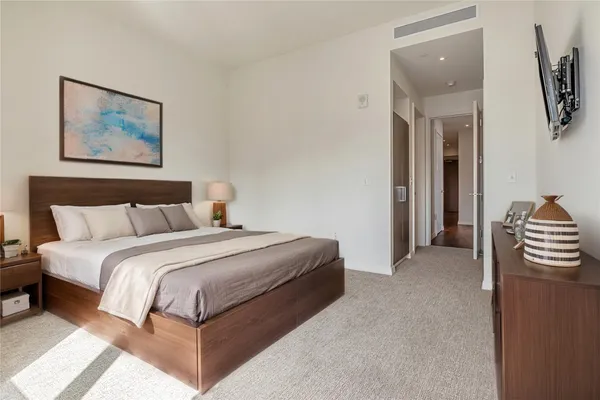a bedroom with bed and a painting