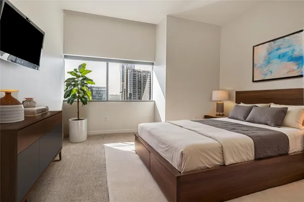 a bedroom with a bed and flat screen tv