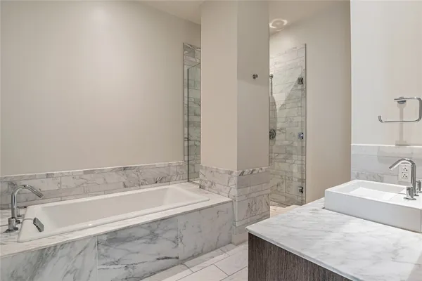 a spacious bathroom with sink shower and bathtub