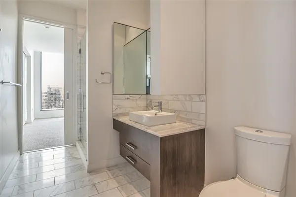 a bathroom with a sink toilet and shower