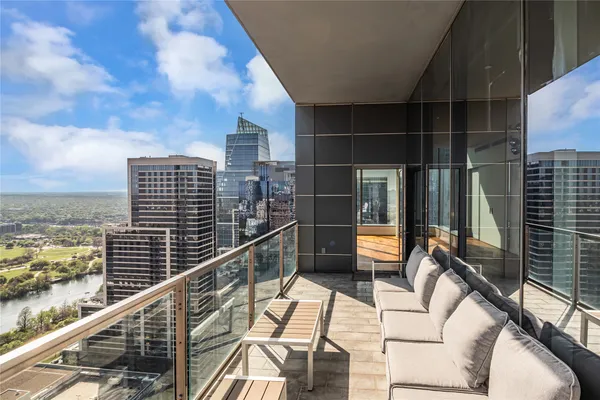 a balcony with an outdoor seating