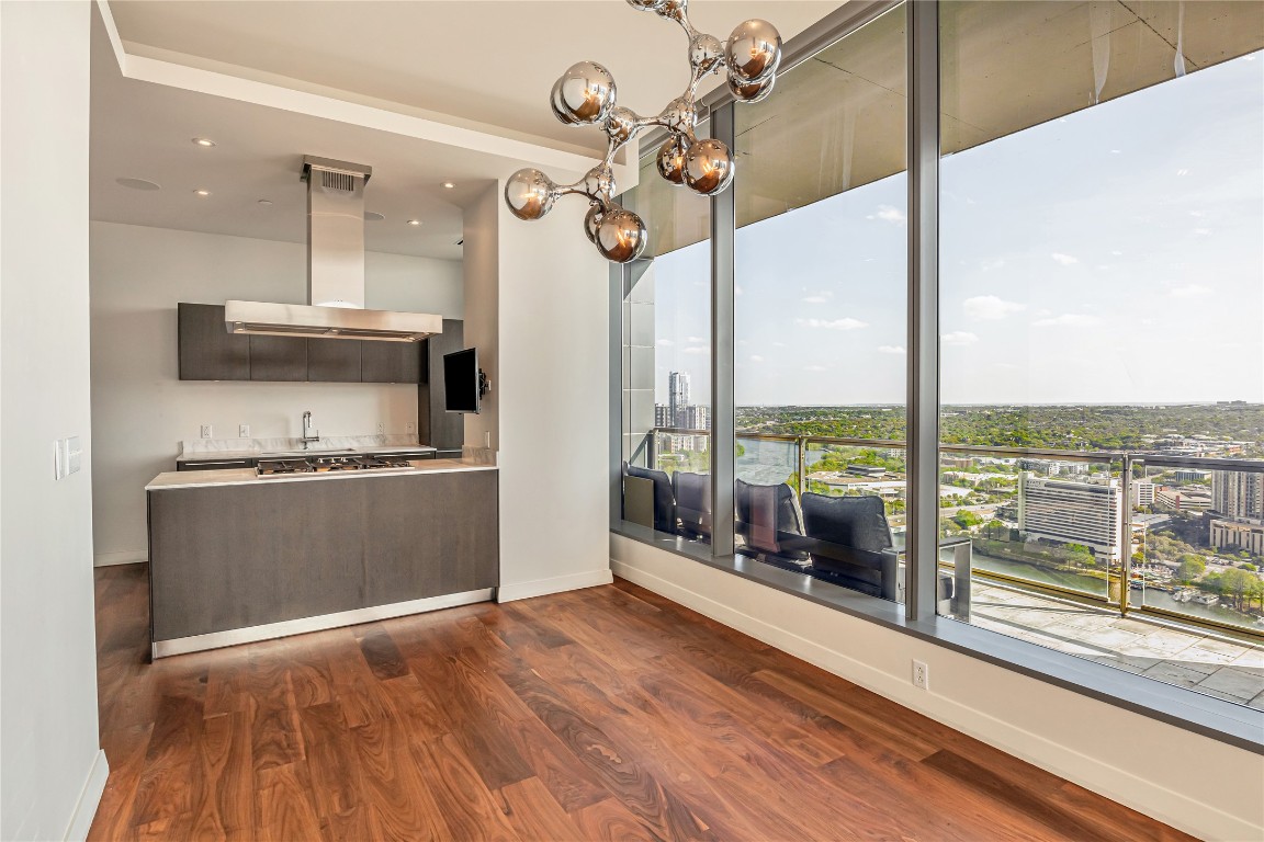 210 Lavaca Street, Unit 2903 Austin, TX 78701 - Photo 32 of 39 a kitchen with kitchen island a counter top a stove and a chandelier