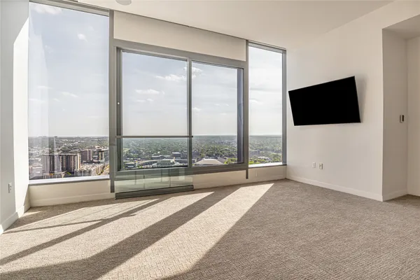 a view of a living room with a large window and a flat screen tv