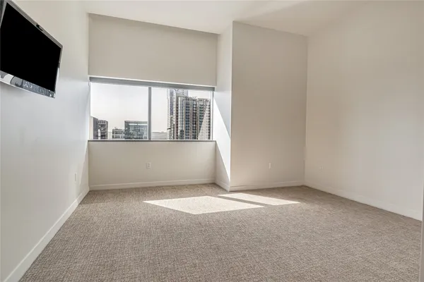 a view of an empty room with a flat screen tv