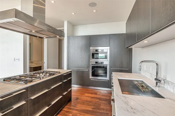 a kitchen with granite countertop a stove and a refrigerator