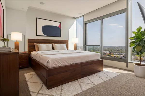a bedroom with a large bed and a window