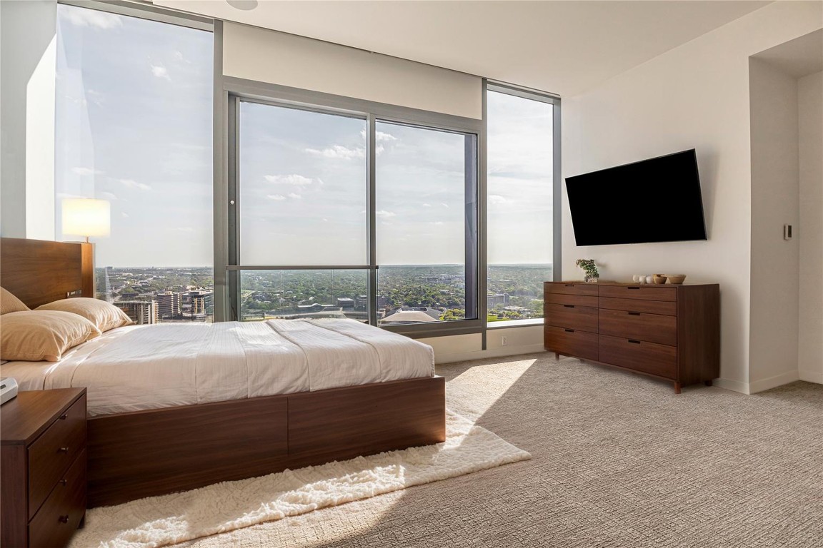 210 Lavaca Street, Unit 2903 Austin, TX 78701 - Photo 10 of 39 a bedroom with a bed and a flat screen tv