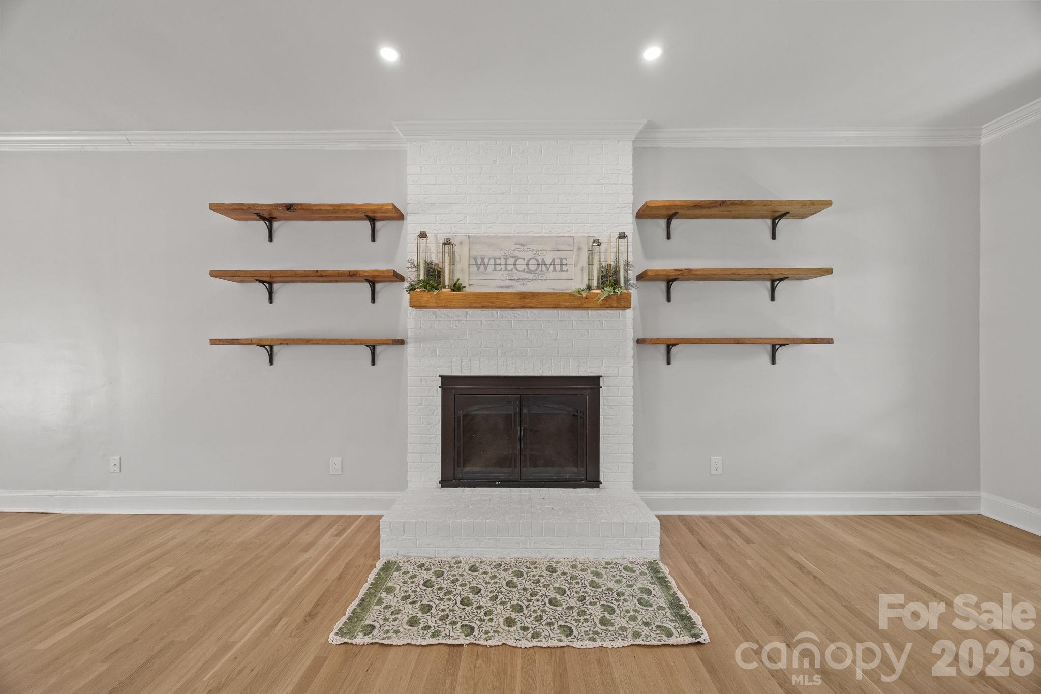 5243 Mintridge Road Mint Hill, NC 28227 - Photo 9 of 43 a living room with a fireplace and a rug