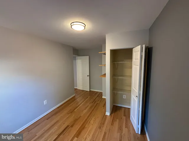 a view of room with wooden floor and bathroom