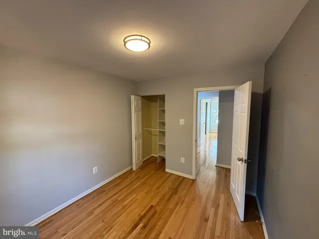 a view of a room with wooden floor and bathroom