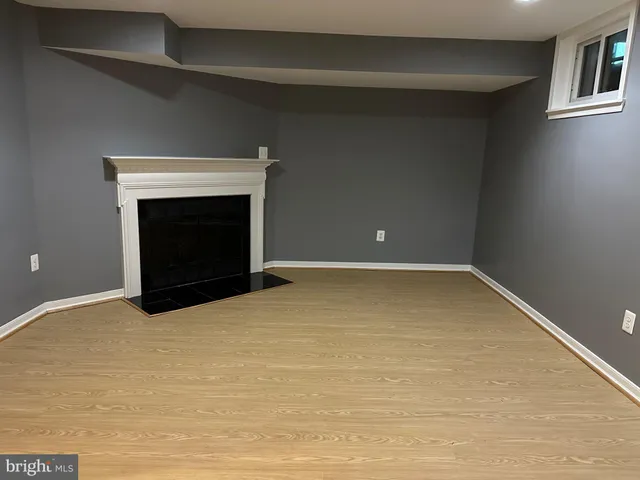 a view of an empty room with a fireplace