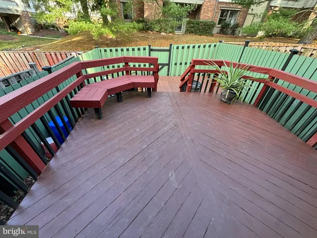 a view of a deck with wooden floor and outdoor seating