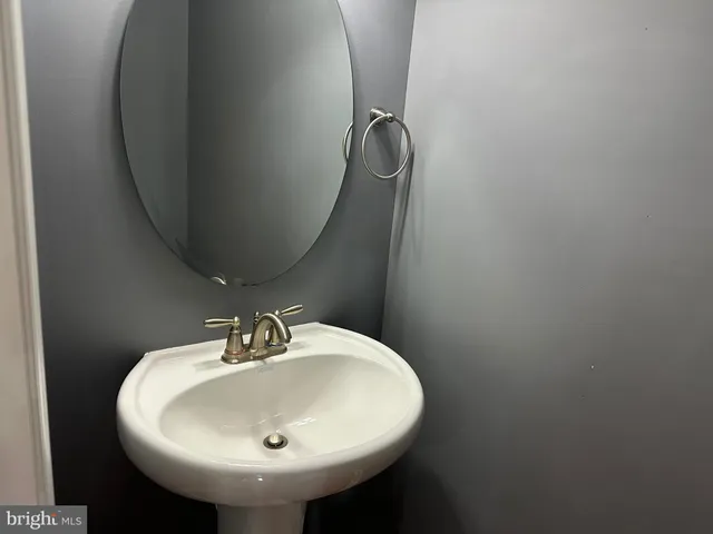 a bathroom with a sink and mirror