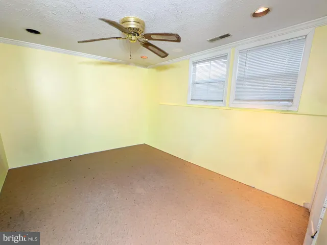 a view of empty room with ceiling fan
