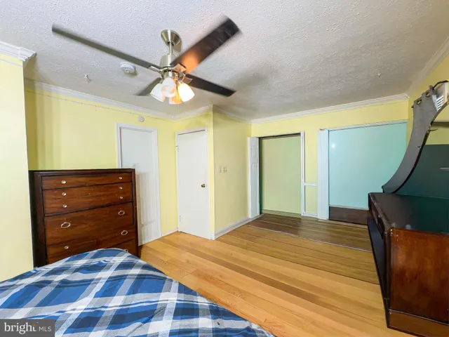 a bedroom with a bed and a dresser