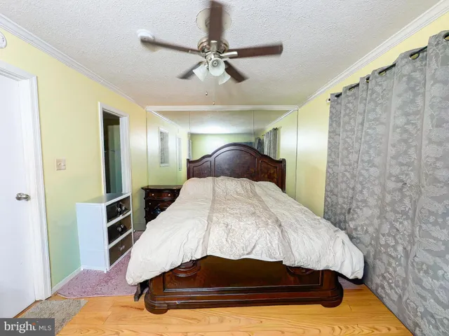 a spacious bedroom with a bed and a chandelier