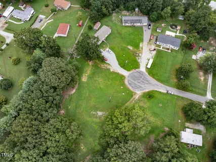 an aerial view of a residential houses with outdoor space and street view