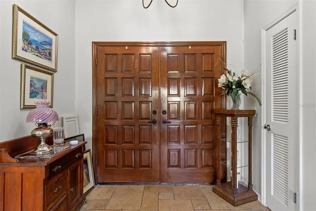 a living room with furniture a bookshelf and a large window