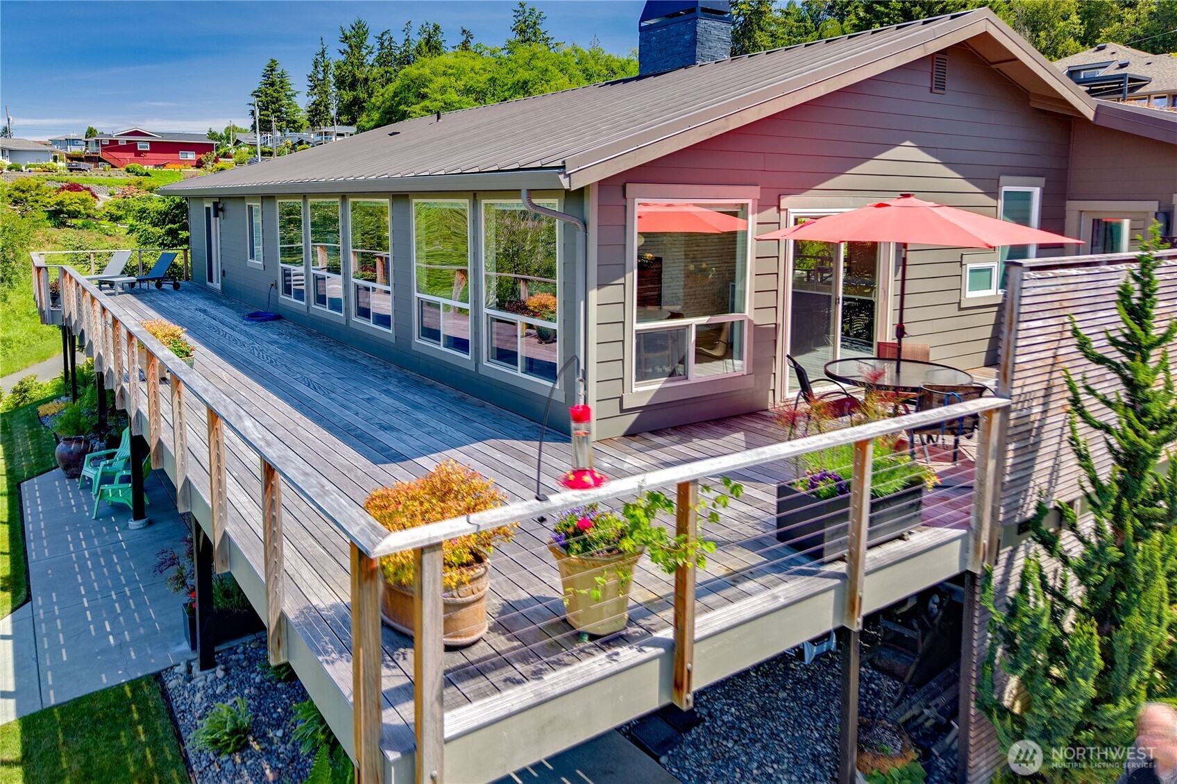 37709 Olympic View Road Northeast Hansville, WA 98340 - Photo 38 of 40 an outdoor sitting area with chairs and umbrella