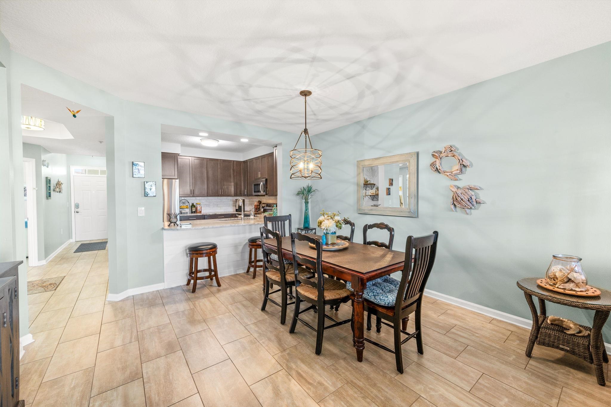 285 Atlantis Circle, Unit 203 St. Augustine, FL 32080 - Photo 17 of 66 a view of a dining room with furniture and wooden floor