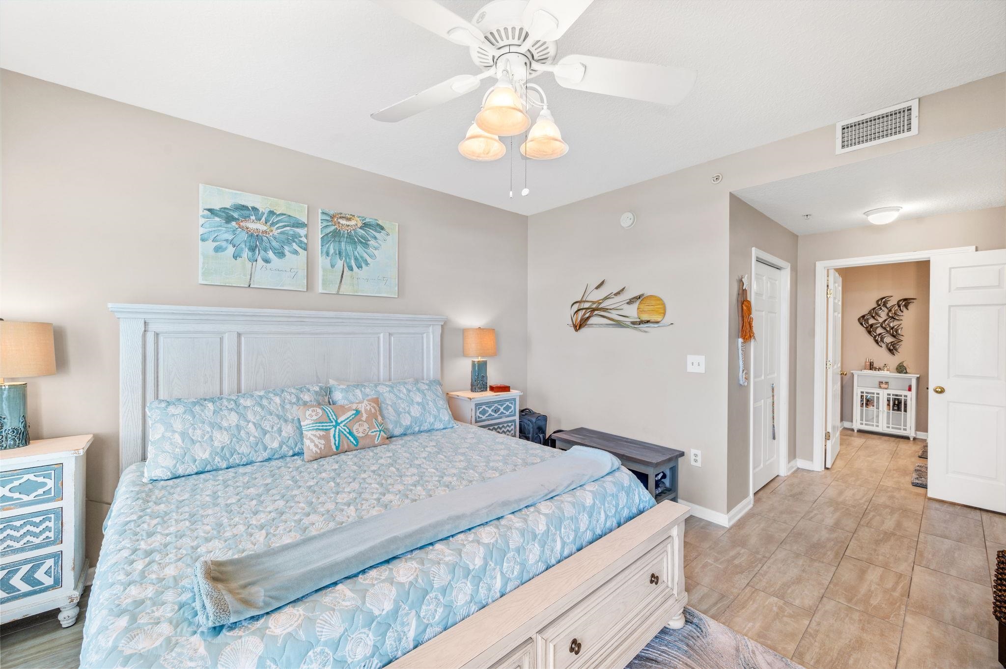 285 Atlantis Circle, Unit 203 St. Augustine, FL 32080 - Photo 22 of 66 a bedroom with a large bed and a chandelier