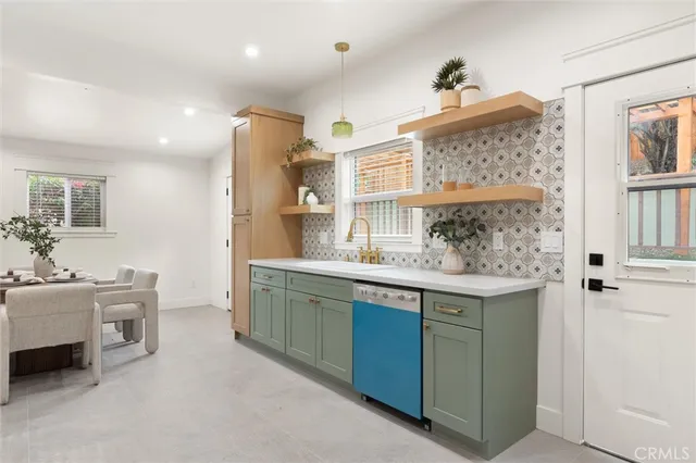 a kitchen with granite countertop a sink and cabinets