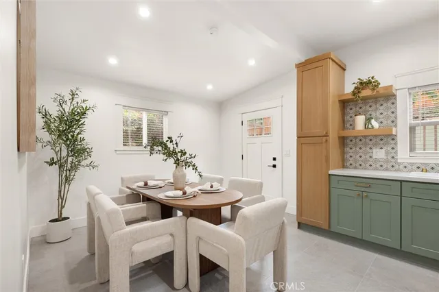 a dining room with furniture and window