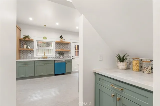 a kitchen with a sink a counter and cabinets