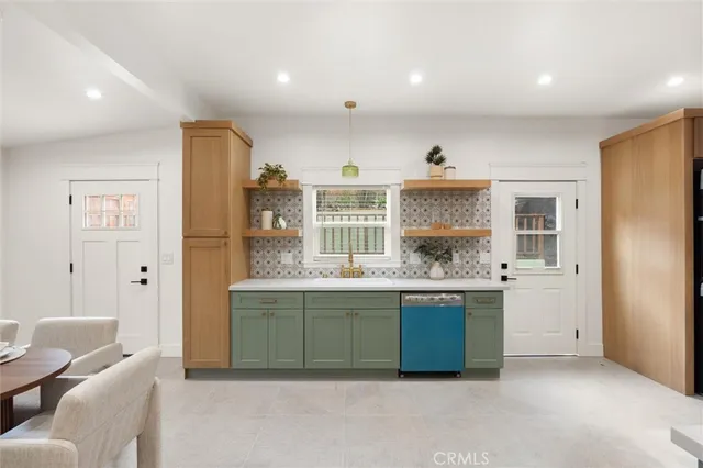 a living room with kitchen island granite countertop furniture and kitchen view