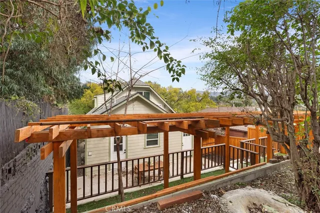 a view of a wooden house with a small yard