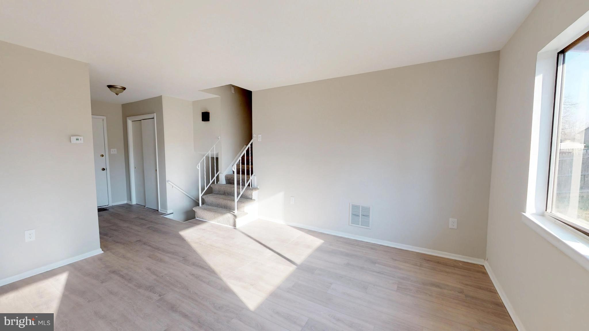 8807 Crandall Road Lanham, MD 20706 - Photo 4 of 13 New Flooring frames this living room dining room