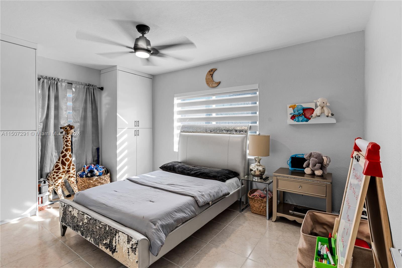 West Little River Miami, FL 33147 - Photo 18 of 29 a bedroom with a bed and a chandelier