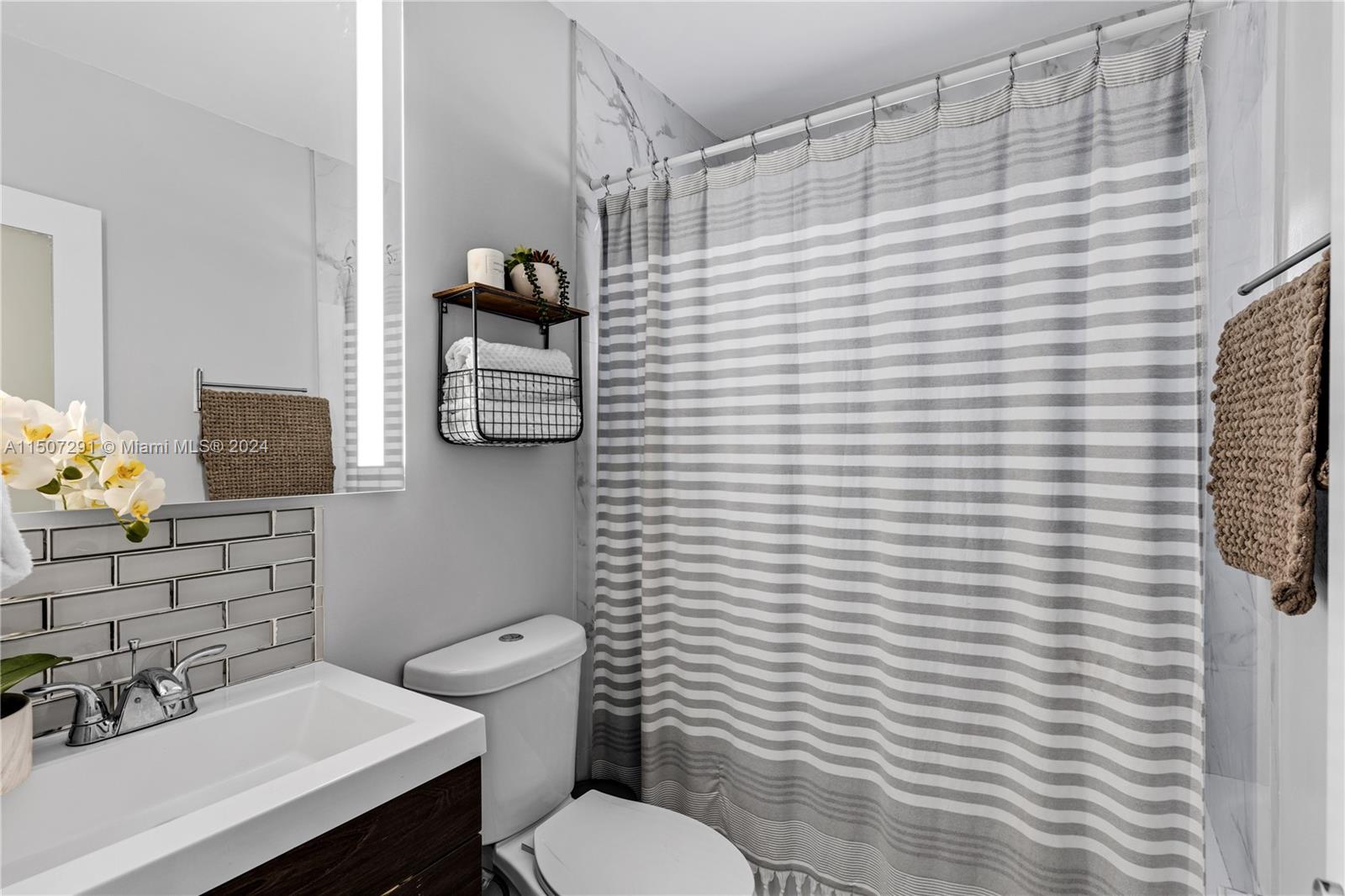 West Little River Miami, FL 33147 - Photo 21 of 29 a bathroom with a sink a toilet and mirror