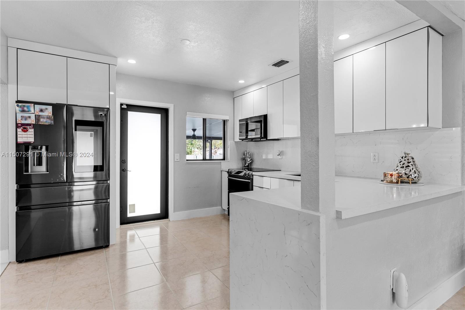 West Little River Miami, FL 33147 - Photo 10 of 29 a kitchen with stainless steel appliances a refrigerator sink and microwave