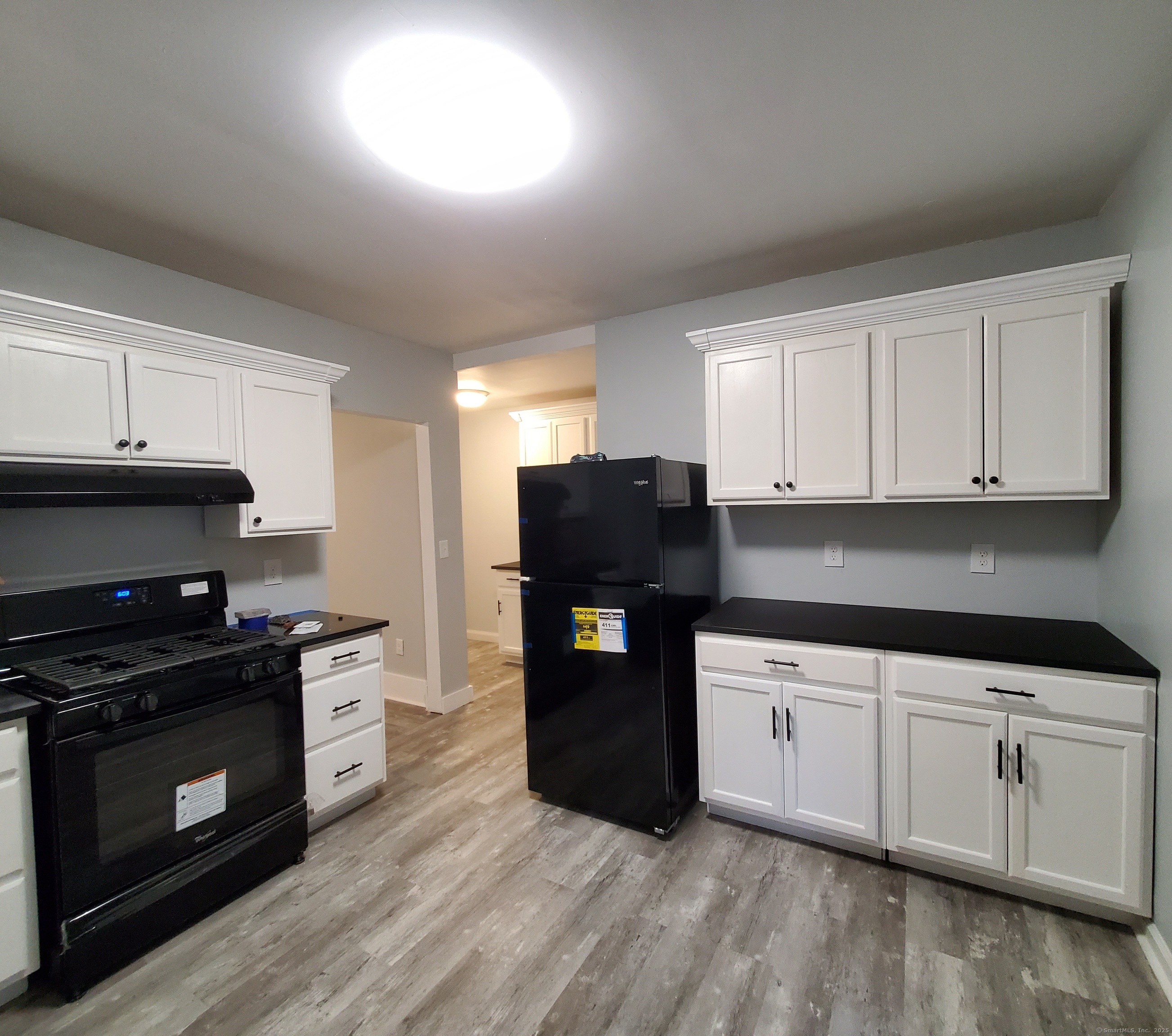 402 Huntington Street New Haven, CT 06511 - Photo 1 of 12 a kitchen with granite countertop white cabinets and stainless steel appliances