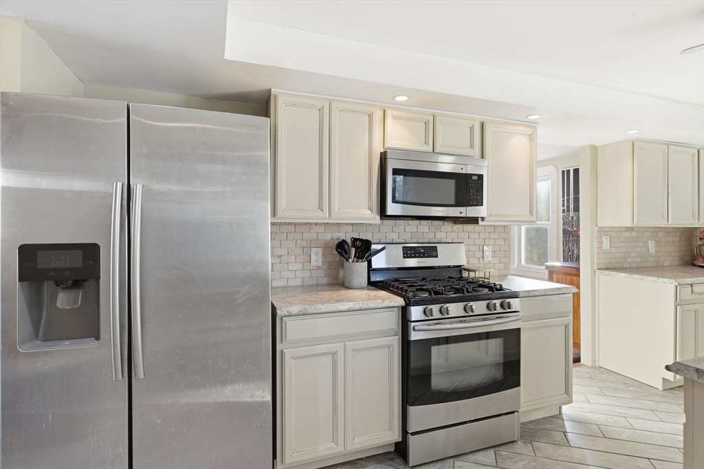 73 Maple Terrace West Springfield, MA 01089 - Photo 12 of 41 a kitchen with a stove microwave and refrigerator