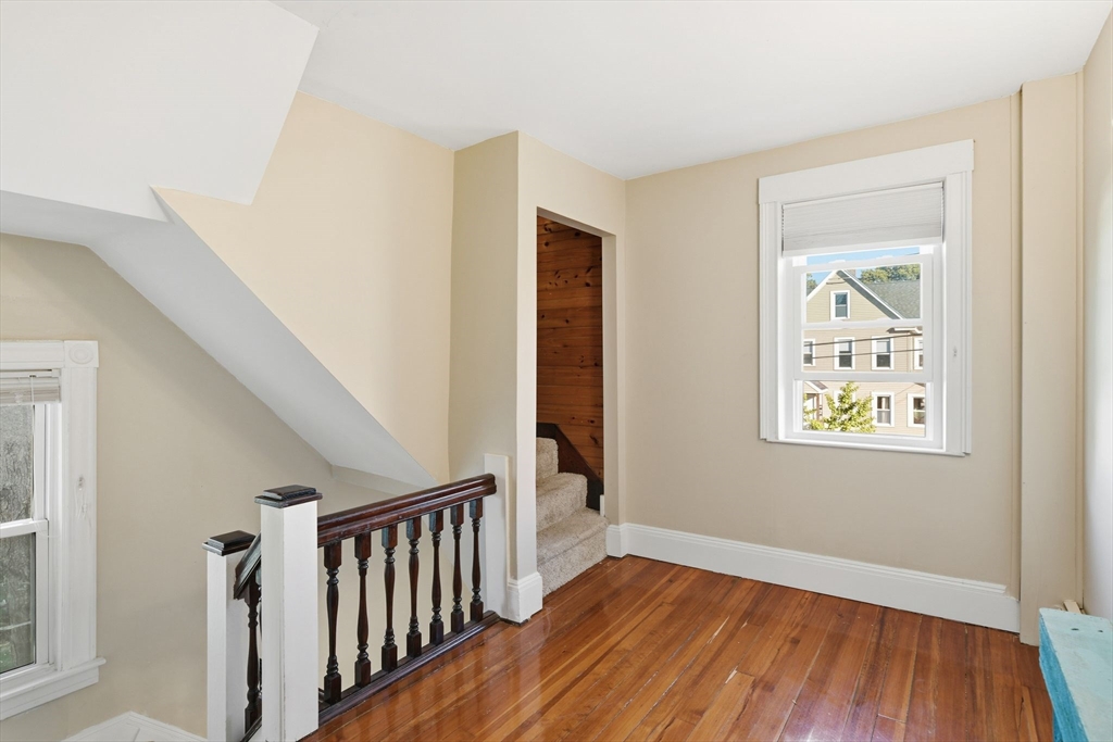 73 Maple Terrace West Springfield, MA 01089 - Photo 17 of 41 a view of an empty room with wooden floor and a window