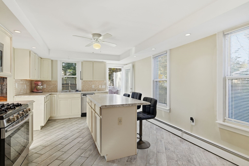 73 Maple Terrace West Springfield, MA 01089 - Photo 10 of 41 a kitchen with a stove a refrigerator and white cabinets