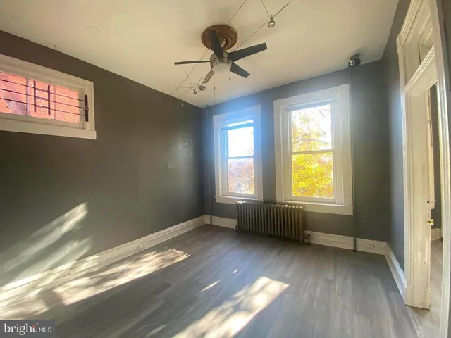 a view of room with window and hardwood floor